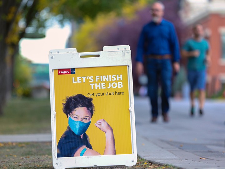  Signs mark a City of Calgary mobile COVID-19 vaccination clinic in Eau Claire on Sept. 22, 2021.