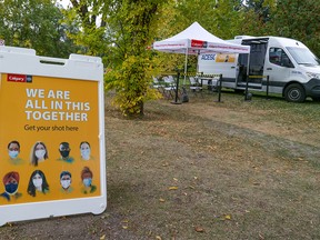 Signs mark a City of Calgary mobile COVID-19 vaccination clinic in Eau Claire near the Peace Bridge on Wednesday, September 22, 2021.