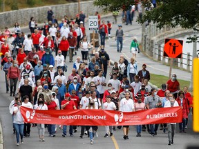 Supporters of Michael Kovrig and Michael Spavor march to mark 1,000 days since the Canadians were arrested in China, during a protest in Ottawa, Ontario, Canada September 5, 2021.
