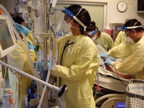 Teams in a crowded Calgary ICU tend to a patient on a ventilator during Alberta's fourth wave of infections.