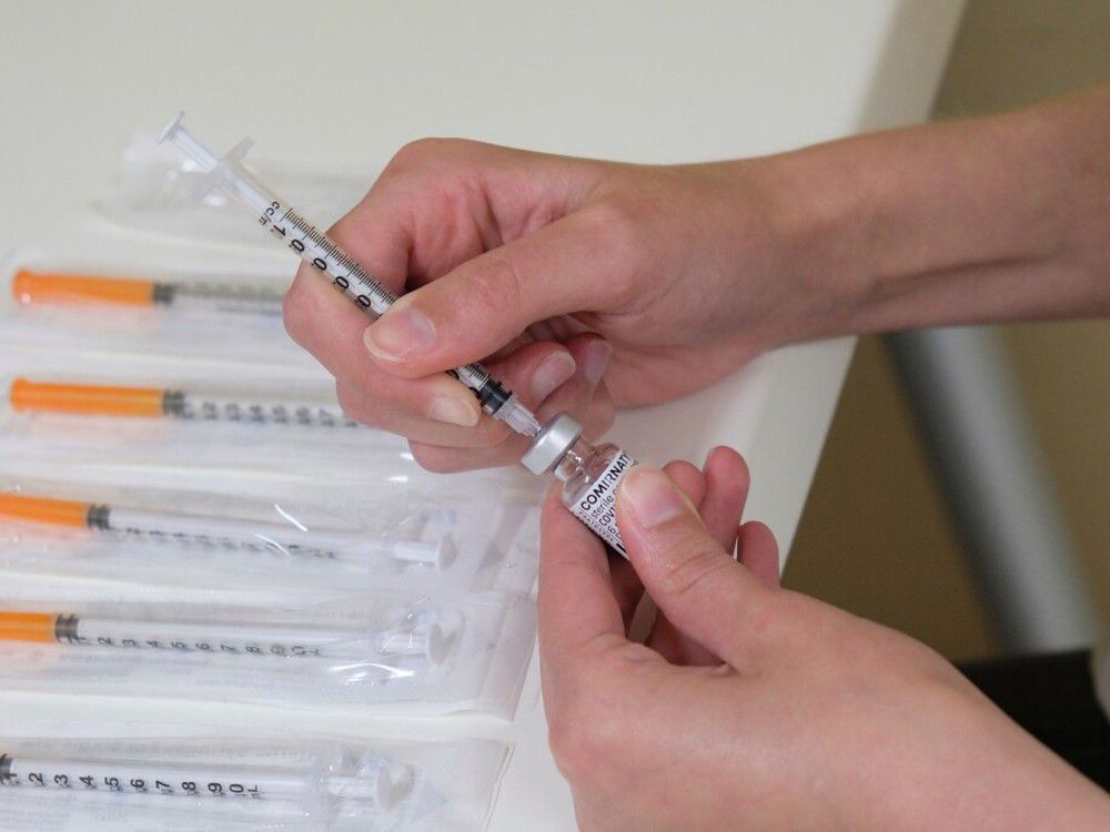  A nurse prepares a dose of the Pfizer-BioNTech vaccine at a vaccination centre.