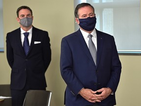 Premier Jason Kenney standing in front of Jason Copping, the newly appointed Minister of Health, during a news conference in Edmonton, September 21, 2021.