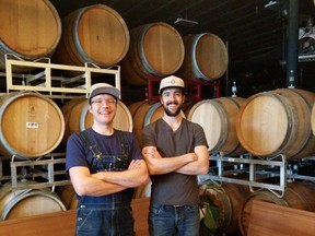 Mike Foniok and David Ronneberg stand in some of the former wine barrels used to age their award-winning beers at The Establishment Brewery in Calgary.