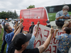 Demonstrators gesture towards a campaign bus as Liberal Leader Justin Trudeau arrives to a campaign stop in Nobleton, Ontario, on Friday, Aug. 27, 2021.
