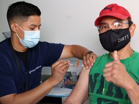 Registered nurse Javier Lopez vaccinates Mario Policarpio at a mobile COVID-19 vaccination clinic at DIRTT Environmental Solutions on Tuesday, September 14, 2021. DIRTT Environmental Solutions organized the clinic for their employees as well as any one else in the community.

Gavin Young/Postmedia