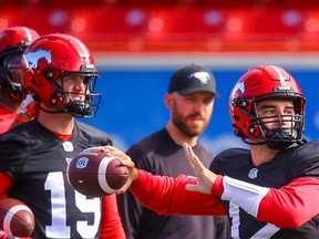 Calgary Stampeders quarterback Jake Maier delivers a pass as fellow-QB Bo Levi Mitchell looks on during practice in Calgary on Saturday.