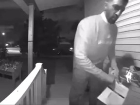 Calgary Skyview MP George Chahal caught on camera allegedly removing an opponent's campaign flyer on Sept. 19, 2021.