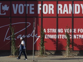 Pedestrians make their way past Edmonton Centre Liberal candidate Randy Boissonnault's campaign office, Monday Sept. 20, 2021. Photo by David Bloom