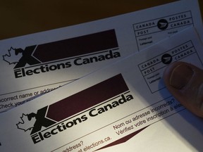 A person holds an Elections Canada voter information card after receiving it in the mail on Tuesday, Aug 31, 2021. Canadians will go to the polls for the federal election on Monday, September 20, 2021.