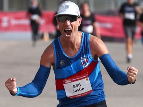 Justin Kurek celebrates as he finishes first in the men's portion of the Scotiabank Calgary Marathon in Calgary on Sunday, September 19, 2021. He finished the 42.2 km course with a time of 2 hours 33 minutes and 15 seconds. Jim Wells/Postmedia
