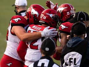 Calgary Stampeders' Jake Maier (12) celebrates a touchdown with teammates on the Edmonton Elks during second half CFL football action at Commonwealth Stadium in Edmonton, on Saturday, Sept. 11, 2021. Photo by Ian Kucerak