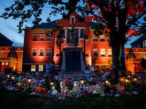 At the former Kamloops Indian Residential School, a makeshift memorial honours 215 children whose remains have been discovered buried near the facility.