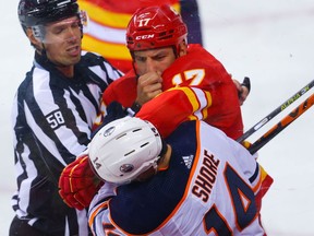 Calgary Flames Milan Lucicwith roughing penalty against  Devin Shore of the Edmonton Oilers during pre-season NHL hockey in Calgary on Sunday, September 26, 2021. AL CHAREST / POSTMEDIA