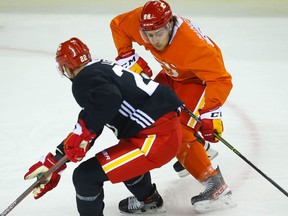 Calgary Flames Andrew Mangiapane battles against Trevor Lewis during 2021 NHL training camp in Calgary on Friday, September 24, 2021. Al Charest / Postmedia