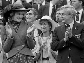 Alberta Premier Peter Lougheed looks over at Princess Diana as she claps for the Canadian team as they pass the Royal box during the opening ceremonies of the Universiade July 1, 1983. Former Alberta premier Peter Lougheed has died at age 84. Prime Minister Stephen Harper's office confirmed that Lougheed died Thursday in the Calgary hospital bearing his name.