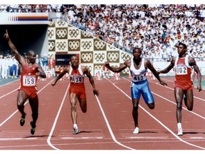 Canadian Ben Johnson (L) signals victory, 24 September 1988, as he wins the men's 100 meters final to take the gold medal over American Carl Lewis (R) in Seoul Olympic Games with a new world record of 9.79 seconds. Left to right : Ben Johnson, Calvin Smith (US) who placed 4th, Linford Christie of Great Britain who placed 3td and Carl Lewis who placed second.  RON KUNTZ/AFP/Getty Images.