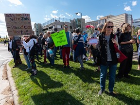 People gather outside the Foothills Medical Centre in Calgary to protest vaccine mandates on Monday, Sept. 13, 2021.