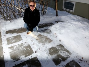 Alan Zakrison and his collection of old sidewalk stamps outside his home in Calgary on January 4, 2017. Postmedia archives.