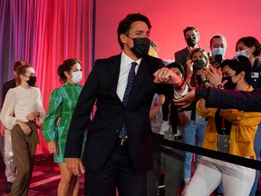 Prime Minister Justin Trudeau greets supporters during the Liberal election night party in Montreal early Tuesday morning, Sept. 21, 2021.
