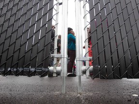 In this file photo taken on August 5, 2017, refugees who crossed the Canada/US border illegally wait in a temporary detention center in Blackpool, Quebec.