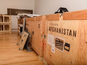 Crates of artifacts are being unloaded for the Mission: Afghanistan exhibition at the Military Museum on Wednesday, October 20, 2021.