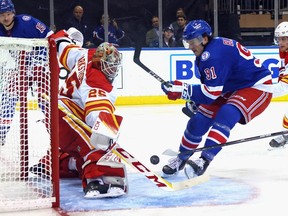Calgary Flames goaltender Jacob Markstrom makes a save on the New York Rangers’ Sammy Blais at Madison Square Garden in New York on Monday, Oct. 25, 2021.