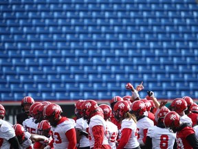 Stampeders players gather at the start of practice at McMahon Stadium in Calgary on Thursday, Sept. 30, 2021.