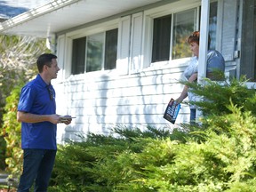 Calgary mayoral candidate Jeff Davison chats with Eleanor Radcliffe while door knocking in the Fairview neighbourhood in southeast Calgary Sunday, October 3, 2021.
