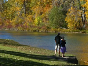 Gerry and Nicole Milner stop to enjoy the colours along the Elbow River in Stanley Park in Calgary on Sunday, October 3, 2021.