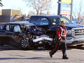 Calgary police are shown at the scene of a three-car accident near Richmond Rd and Sarcee Tr SW in Calgary Sunday, October 31, 2021.