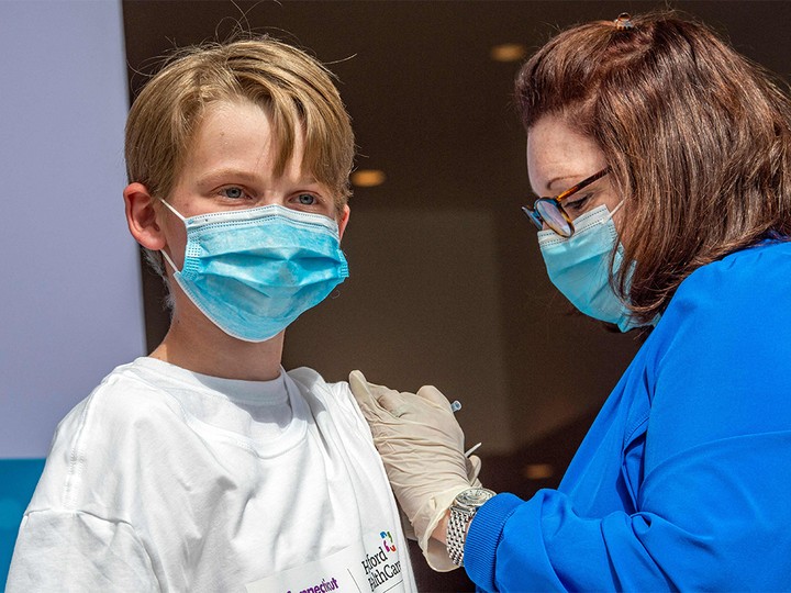  Charles Muro, 13, receives a COVID-19 vaccination in Hartford, Connecticut, on May 13, 2021.