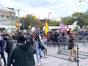 Demonstrators shout slogans outside the Barclays Center, amid the coronavirus disease (COVID-19) pandemic following Brooklyn's Kyrie Irving refusal of vaccination for the COVID-19, in New York, U.S., October 24, 2021, in this screen grab obtained from a social media video.