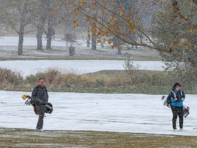 Confederation Park Golf Course golfers deal with a brief snow storm that hit the north part of the city on Monday, October 11, 2021.