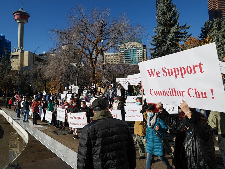  Supporters of re-elected councillor Sean Chu rallied in Olympic Plaza while those calling on him to resign gathered nearby at Calgary City Hall on Sunday, October 24, 2021.