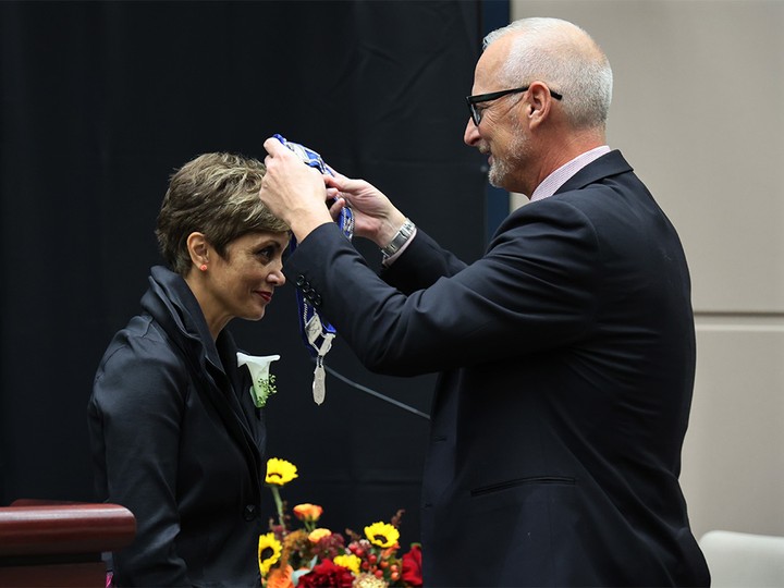  New Calgary Mayor Jyoti Gondek has the chain of office placed by her husband Todd during swearing-in on Monday, October 25, 2021.