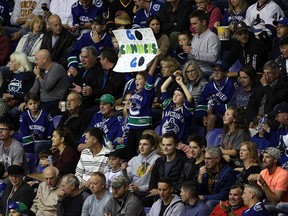 Vancouver Canucks fans cheer on their team during a preseason game against the Calgary Flames in Victoria on Sept. 16, 2019. Full capacity is once again allowed at all sporting events in B.C.