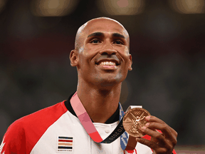 Canadian gold medallist Damian Warner celebrates during the medal ceremony for the men's decathlon event during the Tokyo 2020 Olympic Games, August 6, 2021.