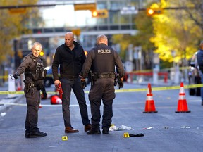 Calgary police investigate a fatal shooting on 8th Ave. between 6 St. and 5 St. S.W. in Calgary on Sunday, October 10, 2021.