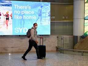 The first International traveller arrives at Sydney Airport in the wake of coronavirus disease (COVID-19) border restrictions easing, with fully vaccinated Australians being allowed into Sydney from overseas without quarantine for the first time since March 2020, in Sydney, Australia, November 1, 2021.