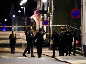Police officers investigate after several people were killed and others were injured by a man using a bow and arrows to carry out attacks, in Kongsberg, Norway, October 13, 2021. Hakon Mosvold/NTB/via REUTERS