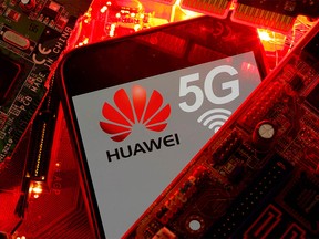 FILE PHOTO: A smartphone with the Huawei and 5G network logo is seen on a PC motherboard in this illustration picture taken January 29, 2020.