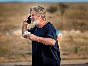 Alec Baldwin speaks on the phone in the parking lot outside the Santa Fe County Sheriff's Office in Santa Fe, N.M., after he was questioned about a shooting on the set of the film Rust on Thursday, Oct. 21, 2021.