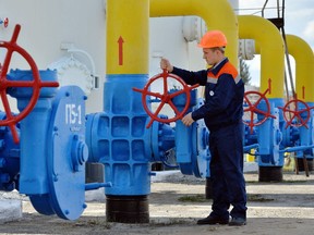 An employee turns a valve at a gas installation during a training exercise near Kiev. Ukraine, in this file photo from April 22, 2015. Columnist Danielle Smith says the recent hikes in energy prices in Europe show the need for traditional energy to bridge the gap with renewable energy.