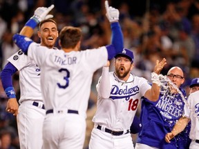 Oct 6, 2021; Los Angeles, California, USA; The Los Angeles Dodgers celebrate the walk-off two run home run hit by left fielder Chris Taylor (3) against the St. Louis Cardinals during the ninth inning at Dodger Stadium. The Los Angeles Dodgers won 3-1. Mandatory Credit: Robert Hanashiro-USA TODAY Sports     TPX IMAGES OF THE DAY