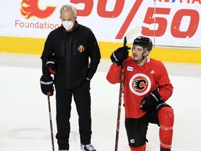 Darryl Sutter is pictured chatting with Matthew Tkachuk during Sutter’s first practice with the Calgary Flames after being named head coach, on March 9, 2021. Gavin Young/Postmedia