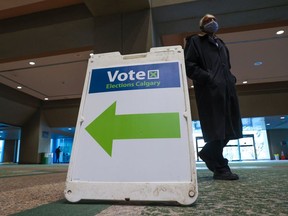 A sign directs voters in the municipal election to the advance polling station at Calgary City Hall on Oct. 4, 2021.