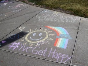 Chalk drawings on the sidewalk outside the Peter Lougheed Centre hospital offer support to health-care workers on Monday, October 4, 2021.
