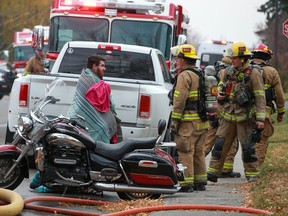 Calgary firefighters deal with the aftermath of a fire in a Forest Lawn home on Wednesday, October 6, 2021.