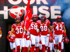 Kicker Rene Paredes leads the Calgary Stampeders onto the field during player introductions before facing the Montreal Alouettes in CFL football on Aug. 20.