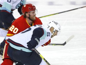 Calgary Flames Blake Coleman battles Seattle Kraken's Mark Giordano in second period pre-season NHL action at the Scotiabank Saddledome in Calgary on Wednesday, September 29, 2021.